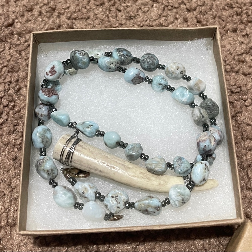 Elegant Beaded Necklace with Horn Pendant
